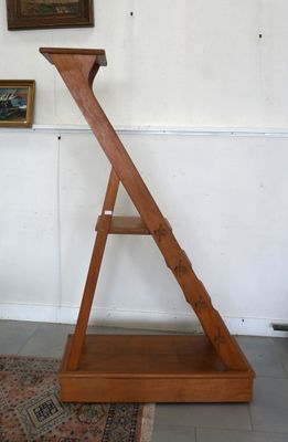 a wooden ladder that is leaning against a wall
