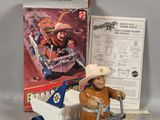 toy figure of a man in a cowboy hat riding a toy truck