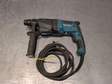 a drill and a cord on a metal surface