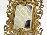 an image of a gold mirror with a face on it