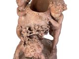 a statue of a boy and a girl holding a vase