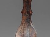 sculpture of a wooden vase on a metal stand on a gray background