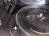 a black microwave with a glass lid on it