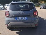 the back end of a grey car parked in a parking lot