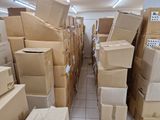 many boxes stacked on top of each other in a room