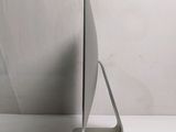 a silver computer on a stand on a white surface