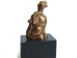 figurine en bronze représentant un chien assis sur un socle en marbre noir