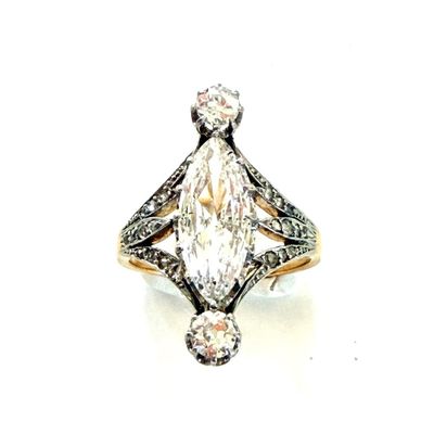 a close up of a diamond ring on a white surface