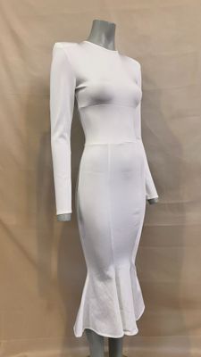 the dress is white and has long sleeves and a frillying hem