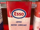 trois bidons de lubrifiant moteur esso sur une table