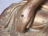 a bronze statue of a person with a snake on it ' s back