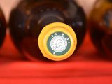 three bottles of wine are lined up on a red cloth