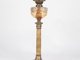 an antique brass table lamp with a glass shade on top