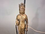 a statue of a person holding a stick in his hand