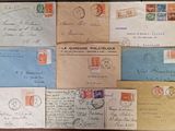 several old envelopes of different sizes and colors are on a table