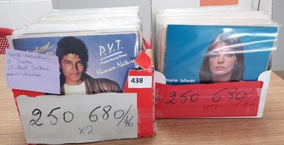 two boxes of cds on a table with a price tag