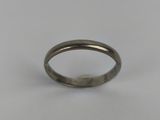 a close up of a silver ring on a white surface