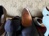several pairs of women ' s shoes are lined up on a shelf