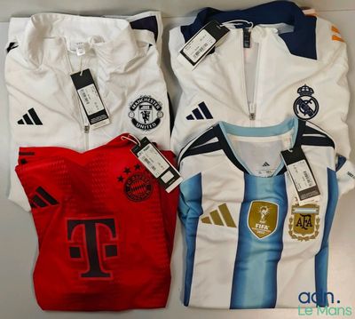 a group of three soccer shirts sitting on top of a table
