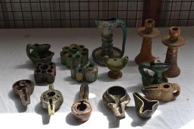 many different types of vases sitting on a table