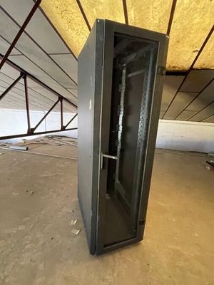 a metal cabinet in the middle of an unfinished room