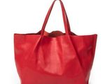a red leather tote bag on a white background
