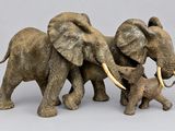 three elephants that are standing next to each other