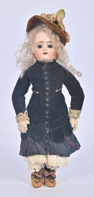 a doll that is wearing a hat and dress