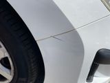 a close up of a car ' s front bumper and tire