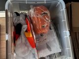 a plastic container filled with assorted items on a shelf
