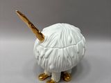 porcelain figurine of a sheep with a golden horn