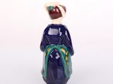 a figurine of a woman sitting on a chair