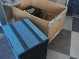 a cardboard box with a computer inside of it on the floor