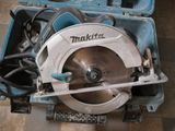 a circular saw in a case on the floor