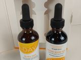 pair of two bottles of vitamin - rich skin care products sitting on a counter