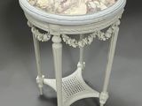 a white table with a marble top on a grey background