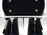 a picture of a black purse with gold hardwares