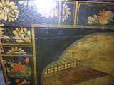 an old wooden chest with a bird cage on it
