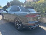 the rear end of a grey volkswagen suv parked in a parking lot