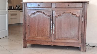 a wooden cabinet with a mirror on top of it