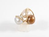 a gold ring with pearls and diamonds on a white background
