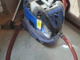 a vacuum that is sitting on the floor next to a door