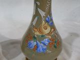 a vase with a bird and flowers painted on it