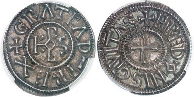 a close up of two silver coins on a white surface