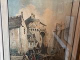 tableau encadré représentant un bâtiment avec une calèche