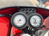 two gauges on the handlebars of a motorcycle