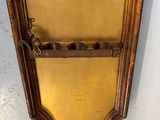 an image of a gold colored mirror hanging on a wall