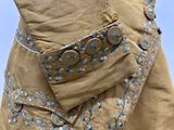 a close up of a person ' s pants with buttons on them