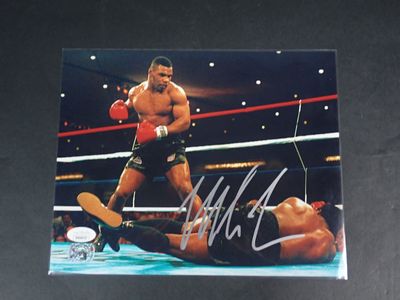 an autographed photograph of a professional boxer in a boxing ring