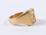 an image of a gold signet ring with a diamond set in the center